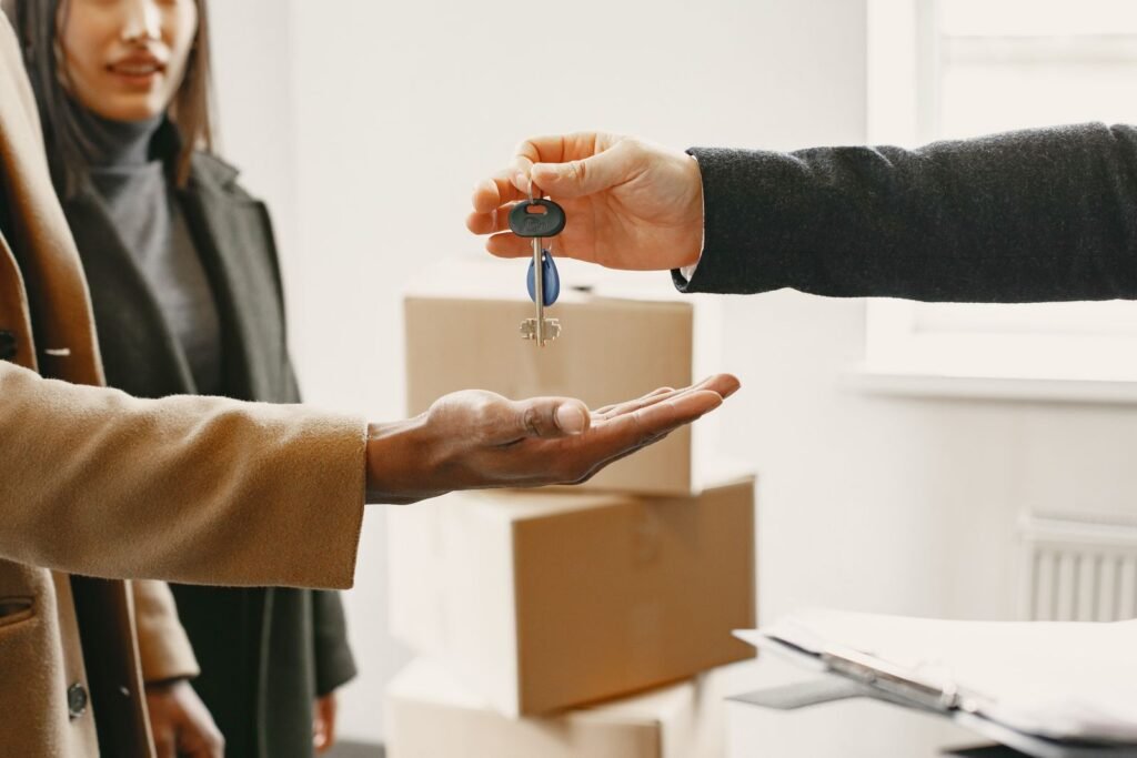 A new homeowner receives keys inside their new home, symbolizing a fresh start