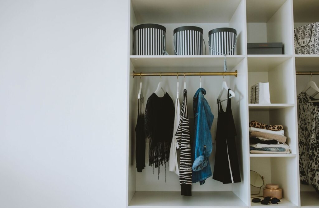 Organized wardrobe with trendy clothes, hangers, and storage