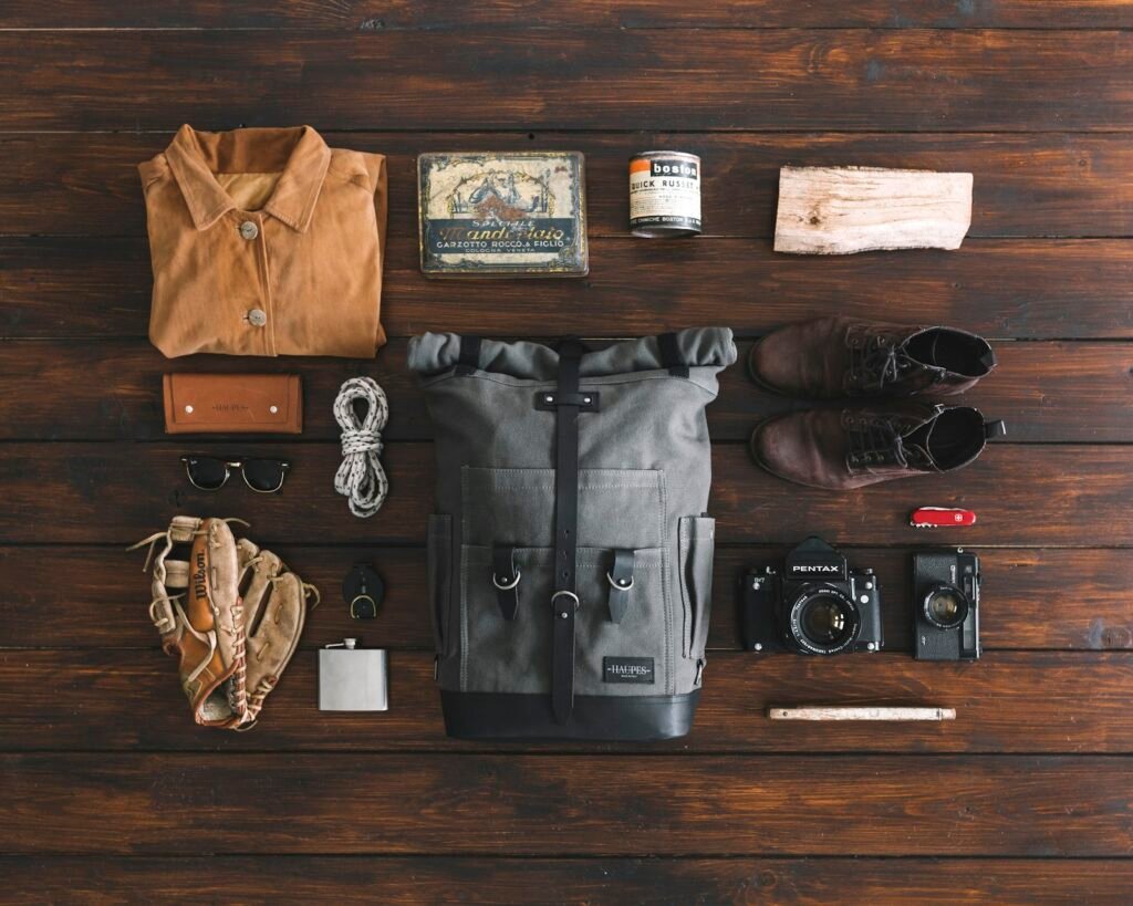 Pair of brown leather boots arranged for a minimalist packing flatlay