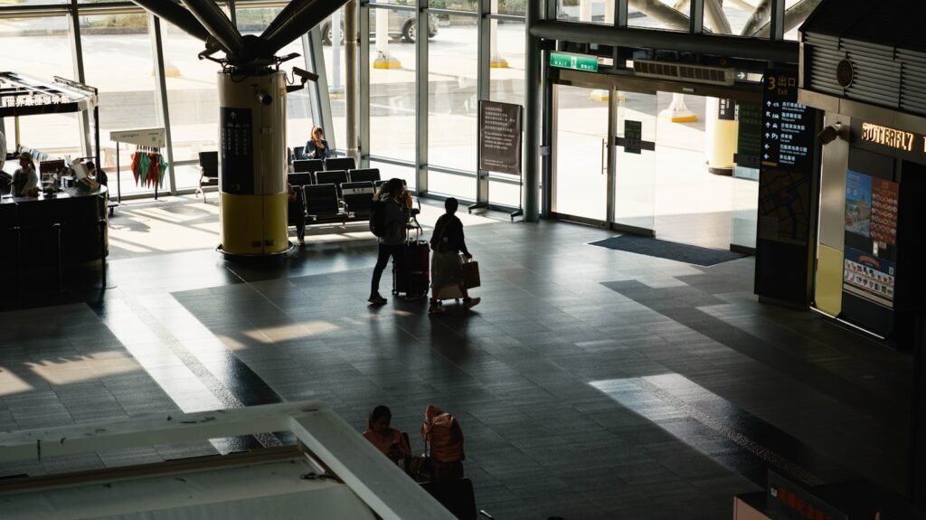 People with luggage in a modern airport terminal