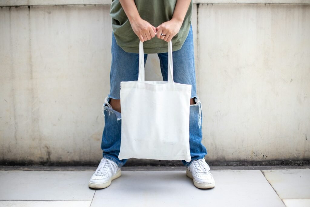 Person carrying a lightweight canvas tote bag