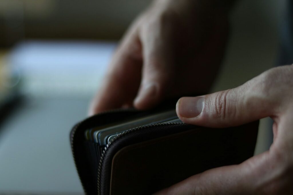 Person holding a leather wallet in their hand