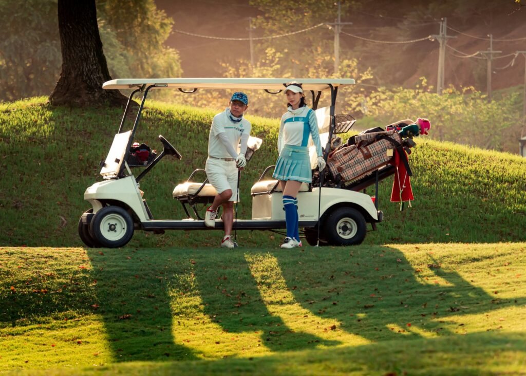 Retired couple standing next to a golf cart enjoying leisure time