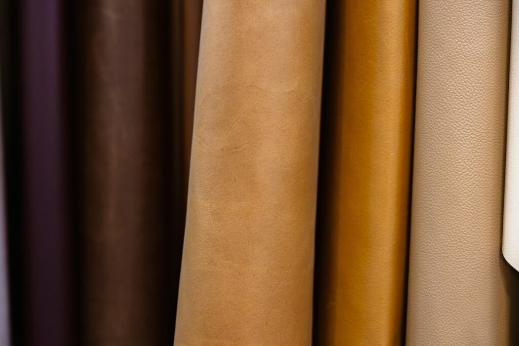 Rolled sheets of tanned leather in a range of colors at a tannery