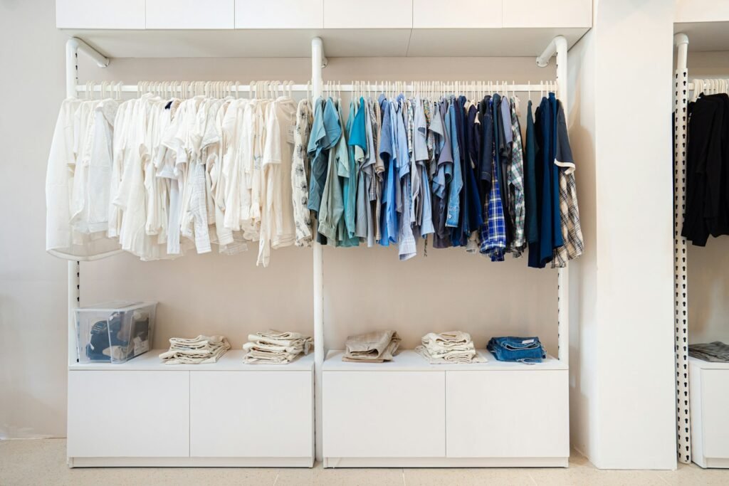 White and blue shirts hanging on a white wooden cabinet