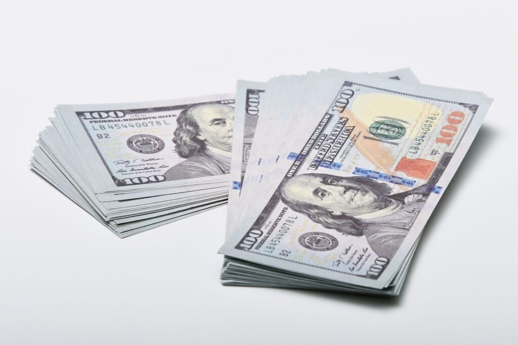 Close-up of two stacks of one hundred dollar bills