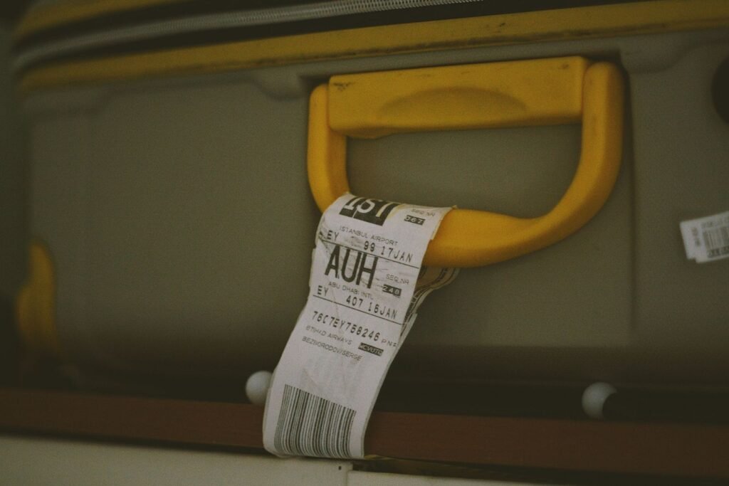 Close-up of a suitcase handle with a visible travel luggage tag