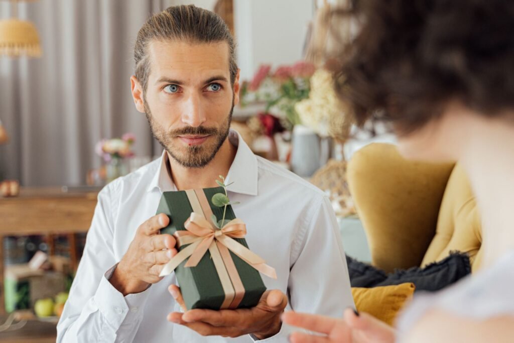 A thoughtful moment captured as a man presents a gift