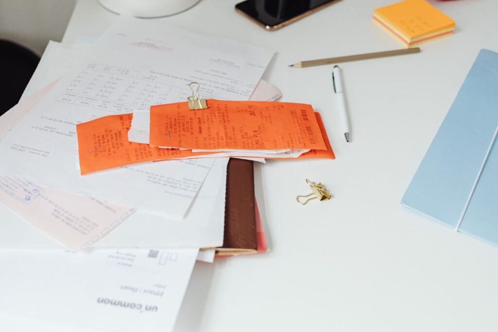 Close-up of a tidy desk with receipts, documents, and office stationery