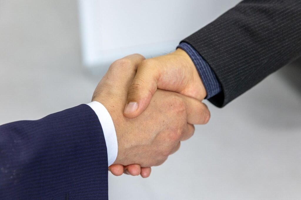 Close-up of two businessmen shaking hands, symbolizing agreement
