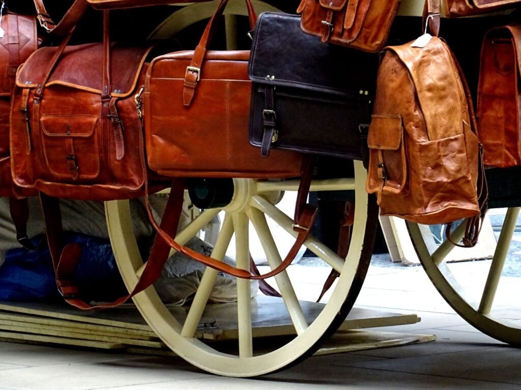 A variety of leather bags elegantly displayed on a classic wood surface