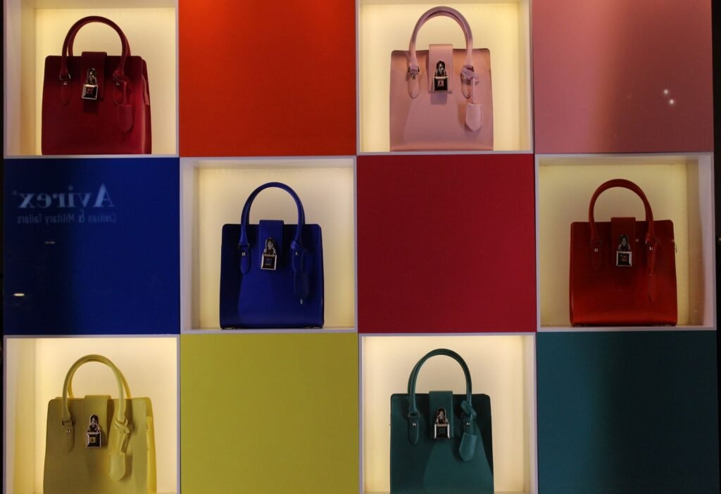 A vibrant display of handbags arranged on multicolored panels