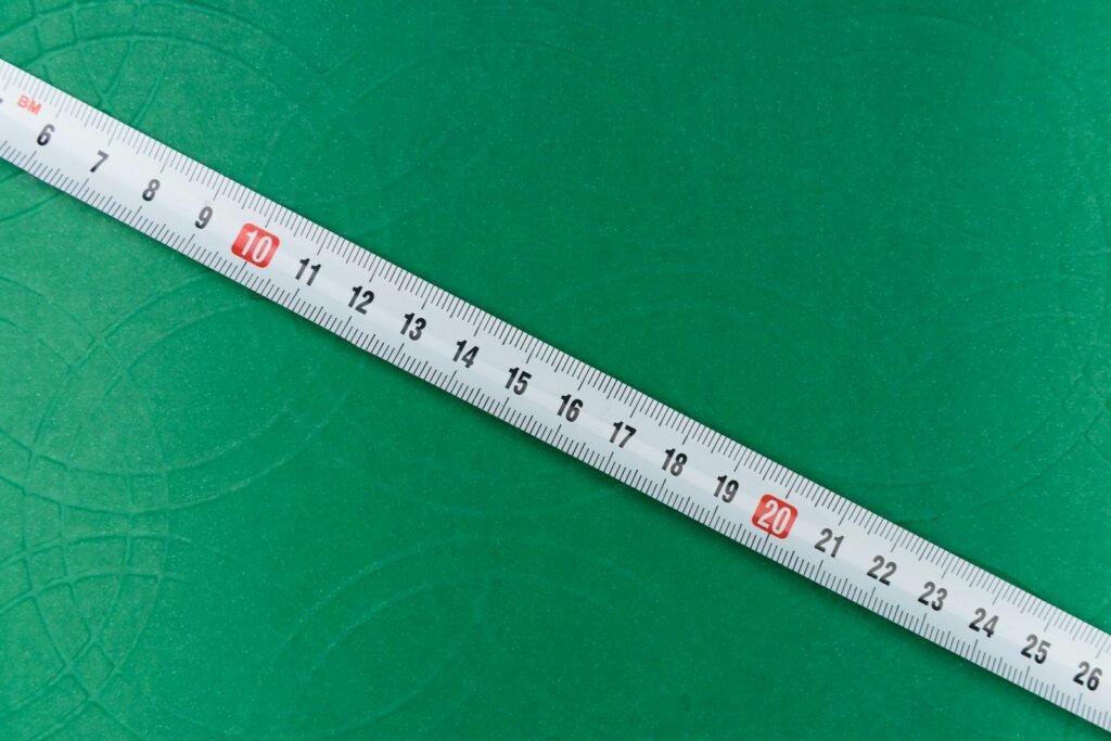 White ruler resting on green textile fabric