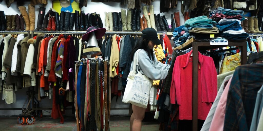 Woman browsing clothes on a rack at a thrift store