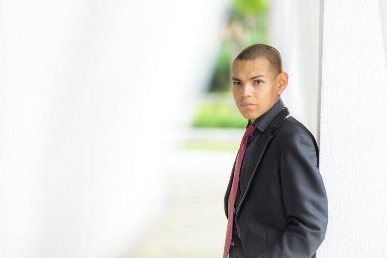 Young male teenager dressed in a formal suit, posing confidently